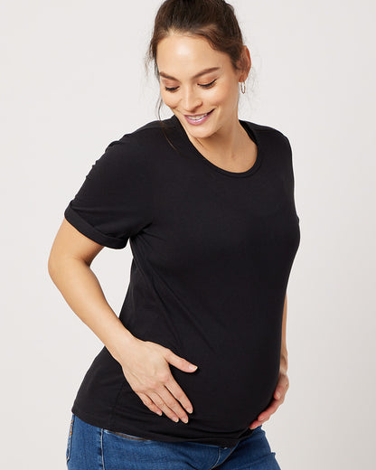 Black cotton rolled sleeve tshirt on smiling pregnant model holding belly and looking down