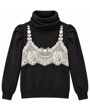 A black long-sleeve turtleneck featuring a white floral lace bralette emrbroidered across the chest