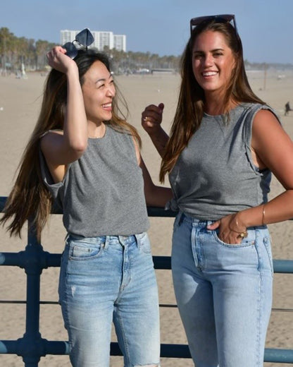Heather grey pima cotton muscle tee on two models laughing at the beach