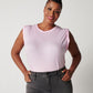 Pink pima cotton muscle tee on smiling black model wearing black jeans with hands in pockets