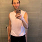 Pink pima cotton muscle tee on male model in black shorts taking picture in leopard shorts