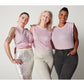 3 fuller bust models hugging and smiling while wearing Pink pima cotton muscle tee in silver sparkle skirt, cream joggers and black jeans