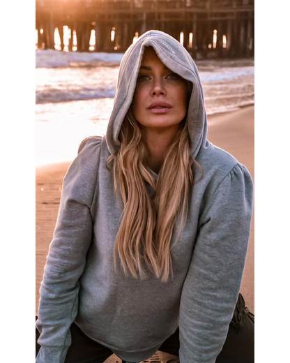 Heather grey cotton fleece long sleeve sweatshirt on model kneeling on beach at sunset