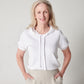 White cotton short sleeve sweatshirt on smiling model with hands in pockets