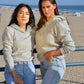 Heather grey cotton fleece long sleeve sweatshirt on 2 models at the beach