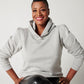 Heather grey cotton fleece long sleeve sweatshirt on smiling model sitting on stool