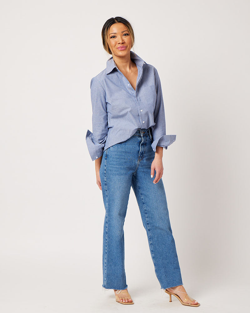 Chambray cotton long sleeve classic button down on asian model wearing blue jeans and clear heels