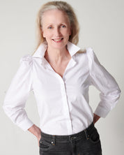 White cotton puff sleeve button down on older model with hands in back pockets