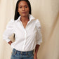 Black, fuller bust model wearing white cotton puff sleeve button down with jeans