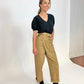 Black organic cotton v-neck sweatshirt on model in tan cargo pants and black heels with hand in pocket