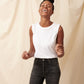 Thin, big boobed black model laughing while wearing white pima cotton muscle tee