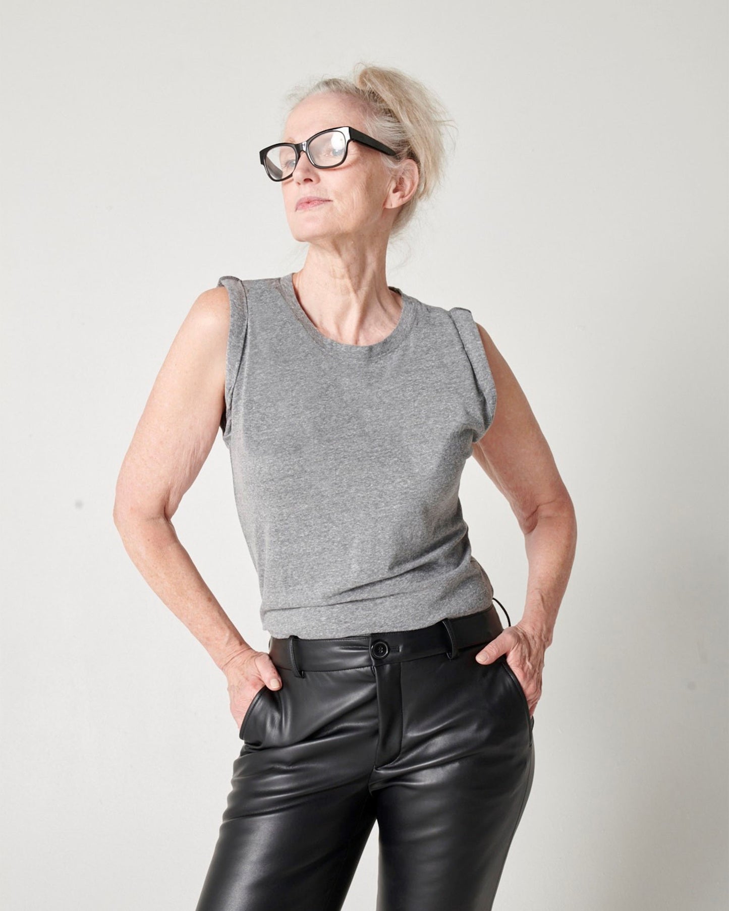 Heather grey pima cotton muscle tee on model wearing glasses and looking to the side