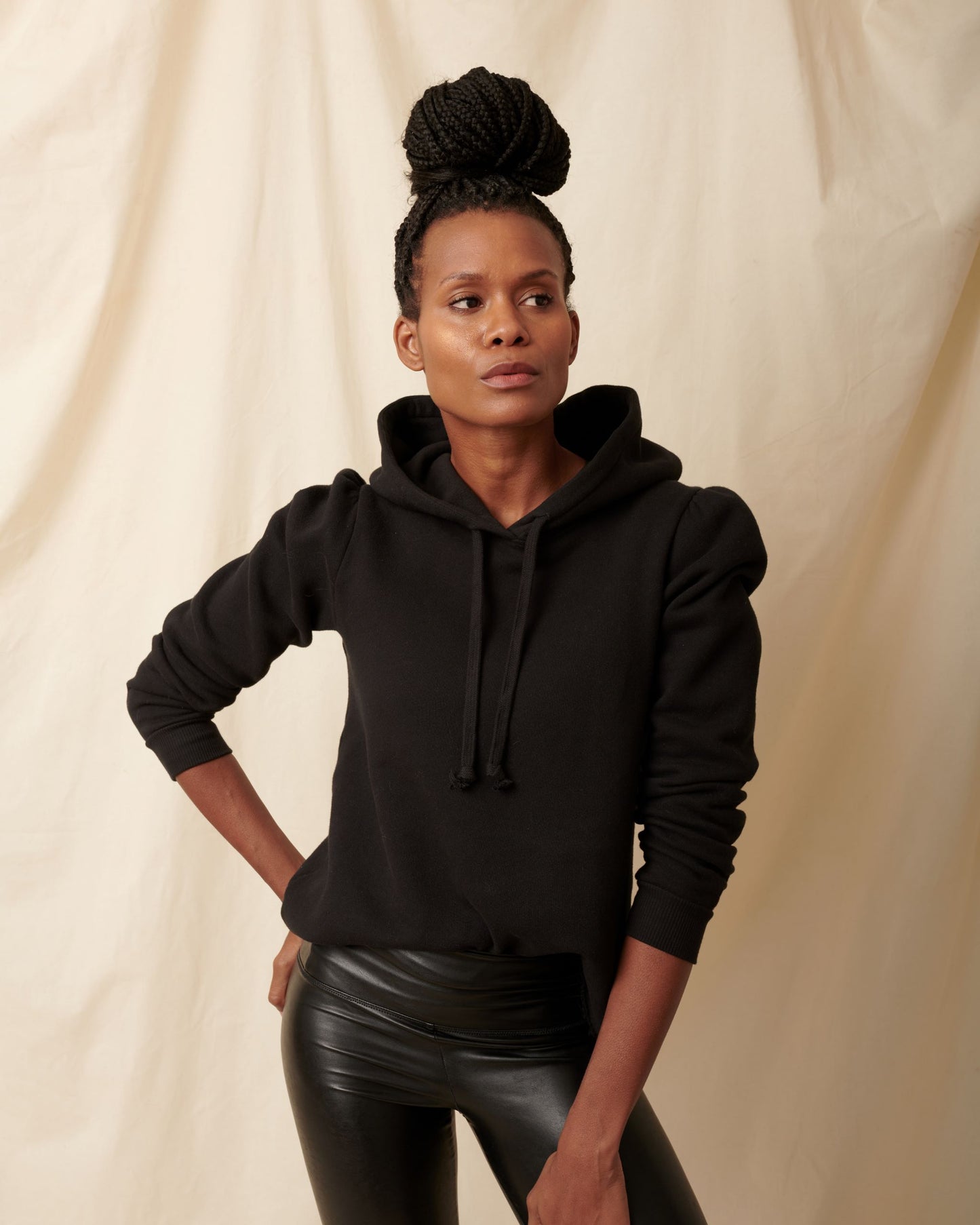Black cotton fleece long sleeve sweatshirt on model looking to the side