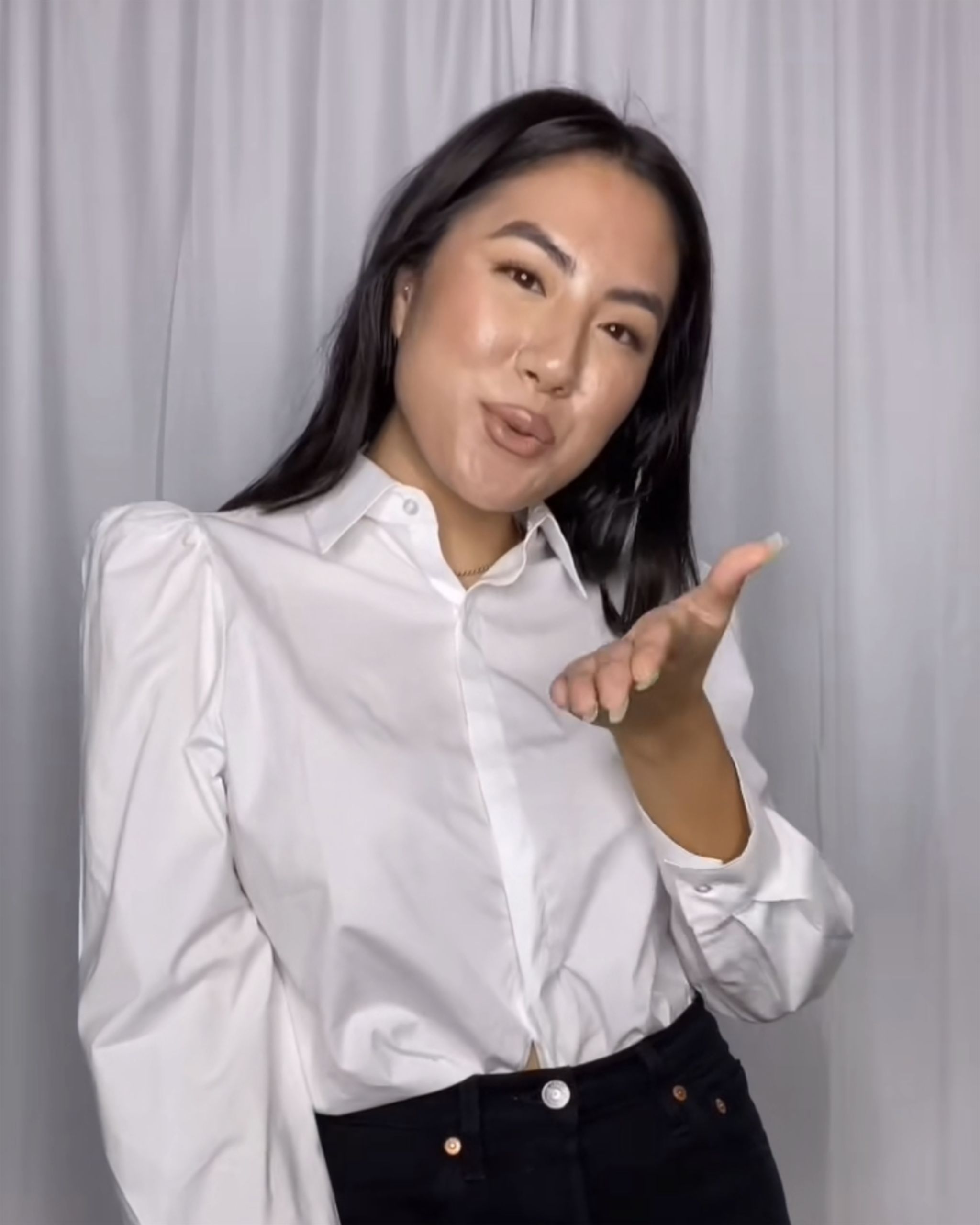 model blowing a kiss