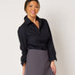 Black cotton long sleeve classic button down tucked into grey skort on smiling asian model