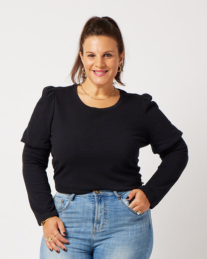 Black organic cotton double sleeve crewneck sweatshirt on smiling model wearing blue jeans, gold jewelry and ponytail
