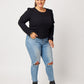Black organic cotton double sleeve crewneck sweatshirt on model wearing ripped blue jeans and black boots with hand in pocket