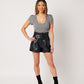 Heather grey supima cotton scoopneck tulip sleeve tee on smiling asian model wearing black leather shorts and black booties with hand on hip
