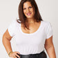 White supima cotton scoopneck tulip sleeve tee on smiling model with hand on hip