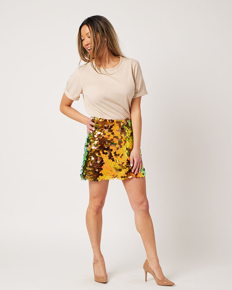 Latte cotton rolled sleeve tshirt tucked into colorful sequin skirt on smiling asian model looking to side
