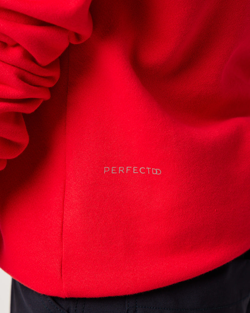Logo detail of Varsity Red cotton fleece long sleeve sweatshirt on pregnant model