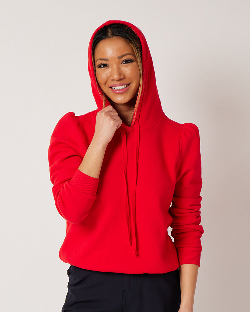 Varsity Red cotton fleece long sleeve sweatshirt on smiling model holding hood