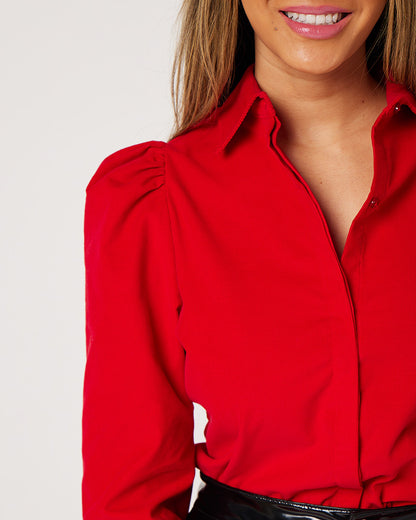 Shoulder detail of Red Japanese corduroy puff sleeve button down on smiling model