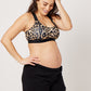 Leopard recycled polyester sports bra on pregnant model wearing black cotton sweat shorts and looking down