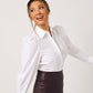 Side profile of white cotton puff sleeve button down on smiling, fuller bust model looking to the side