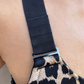 Strap detail of shoulder adjustability on leopard recycled polyester sports bra